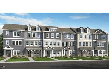 Row of newly built townhomes showing facade and design elements with professionally landscaped yards at 408 Rowe Way, Knightdale, NC 27545
