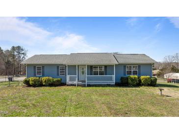 Charming single-story home featuring a cozy front porch and well-manicured lawn at 41 Rock Bluff Ln, Kittrell, NC 27544