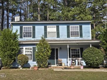 Charming two-story home with light-blue siding, dark-green shutters, and landscaped front yard at 4610 Tyne Dr, Durham, NC 27703