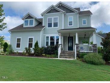 Charming two-story home with a well-manicured lawn and inviting front porch at 465 Claremont Dr, Chapel Hill, NC 27516