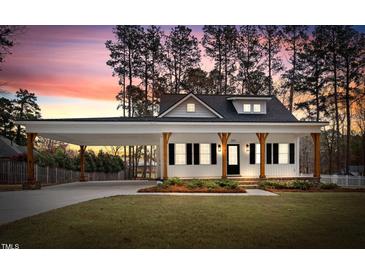 Beautiful home with a covered parking area and a lawn at 5450 Hunter Hill Rd, Rocky Mount, NC 27804
