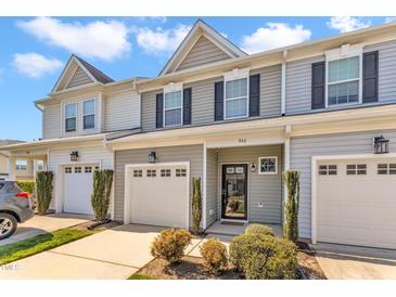 Charming townhome featuring a one car garage, covered entrance, and neatly manicured landscaping at 946 Consortium Dr, Raleigh, NC 27603