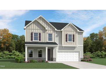 Charming two-story home with gray siding, stone accents, and a welcoming front porch at 1004 Red Roses Ave, Durham, NC 27703