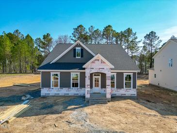 Charming single-story home featuring a classic gray exterior and a welcoming front porch at 195 Duncan Creek Rd # 123, Lillington, NC 27546