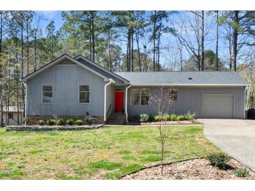 Charming single story home with a neutral paint and mature trees at 2 Edgestone Pl, Chapel Hill, NC 27517