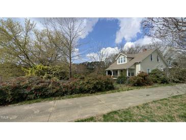 Charming home featuring a well-maintained exterior, fenced front yard, and inviting curb appeal at 2121 Allensville Rd, Roxboro, NC 27574
