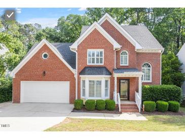 Charming brick home with manicured landscaping and attached two-car garage at 2812 Dahlgreen Rd, Raleigh, NC 27615