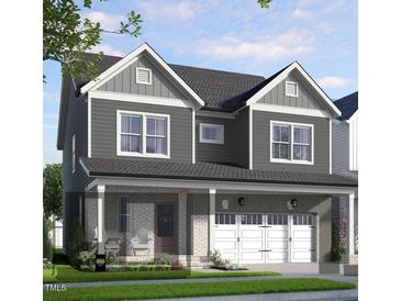 Charming two-story home with a brick-accented front porch and a two-car garage at 296 Beacon Dr, Pittsboro, NC 27312