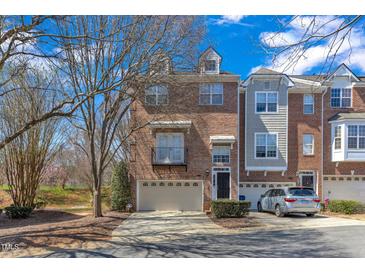 Charming townhome with brick facade, balcony, garage and landscaped front yard at 3001 Imperial Oaks Dr, Raleigh, NC 27614