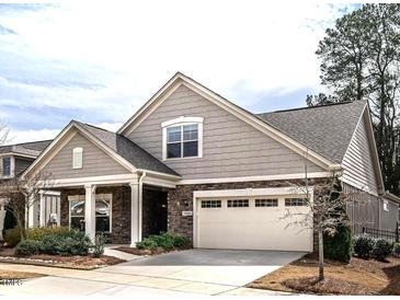 Charming single-Gathering home with a well-manicured lawn and a two-car garage and stone details at 3009 Kildaire Dairy Way, Apex, NC 27539