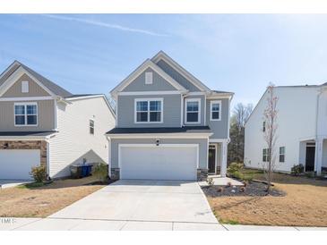 Charming two-story home with a well-maintained front yard and attached two-car garage at 3144 Star Gazing Ln, Durham, NC 27703