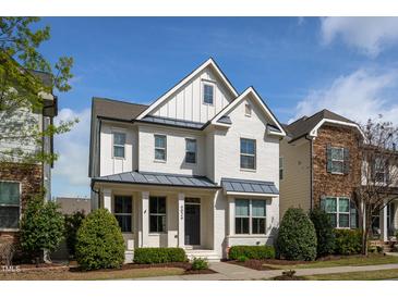 Charming two-story home with white brick, manicured landscaping, and a welcoming front entrance at 4026 Overcup Oak Ln, Cary, NC 27519