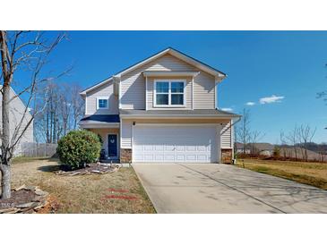 Inviting two-story home with a two-car garage, light siding, and a manicured front lawn at 507 Southwick Pl, Mebane, NC 27302
