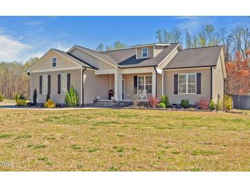 Charming single-story home with inviting front porch and manicured landscaping at 511 Mcarthur Rd, Broadway, NC 27505