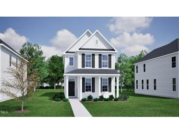 Charming two-story white home with black shutters and a well-manicured lawn on a sunny day at 728 Georgia'S Landing Pkwy # 9, Raleigh, NC 27603