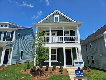 Two-story home with a charming front porch and manicured landscaping for curb appeal at 732 Georgia'S Landing Pkwy # 8, Raleigh, NC 27603