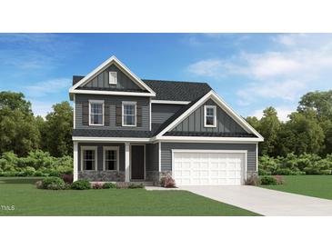 New construction home with a two-car garage, stone accents, and manicured lawn on a sunny day at 1010 Red Roses Ave, Durham, NC 27703
