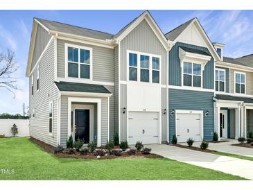 Charming townhome exterior with gray siding, white trim, and well-manicured landscaping at 108 Ripple Way # 319, Clayton, NC 27520