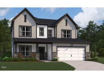 Inviting two-story home featuring vertical siding, stone accents, and an attached two-car garage at 115 Moonflower Ln # Homesite 259, Clayton, NC 27520