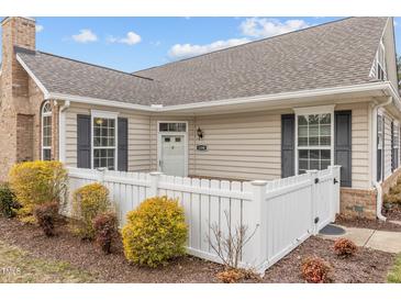 Inviting single-story home featuring a manicured front yard with a charming white picket fence at 1159 Blue Bird Ln, Wake Forest, NC 27587