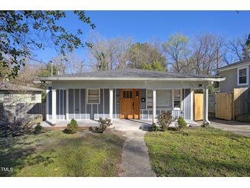 Charming blue-gray home with a welcoming front porch and a beautiful wood front door at 1213 Lincoln St, Durham, NC 27701