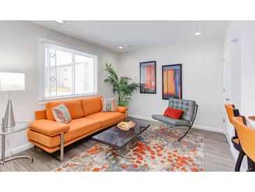 Inviting living room featuring an orange sofa, stylish decor, and an area rug at 1309 Hudson Ave # D2, Durham, NC 27705