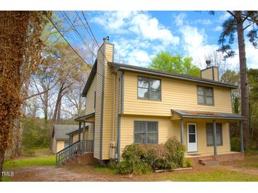 Charming two-story home with a classic exterior, including chimneys and a well-manicured front yard at 2809 Haven Rd, Raleigh, NC 27610