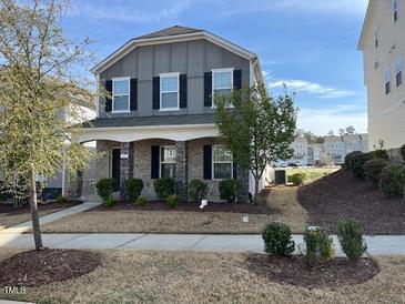 Charming two-story home featuring a well-maintained lawn and covered porch perfect for relaxing outdoors at 307 King Closer Dr, Cary, NC 27519
