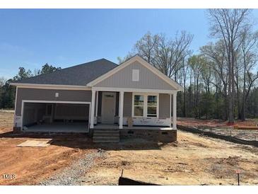 Charming single-story home featuring a two-car garage, covered entrance, and double hung windows at 381 Old Fashioned Way, Lillington, NC 27546