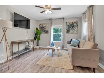 Cozy living room features neutral tones, stylish decor, and modern furnishings at 4408 Poplar Dr, Raleigh, NC 27610