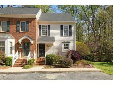Charming townhouse with brick and siding exterior and manicured front yard at 6750 Olde Province Ct, Raleigh, NC 27609