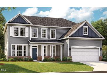 Charming two-story home with gray siding, white trim, and a well-manicured lawn at 740 Portland Rose Dr, Knightdale, NC 27545