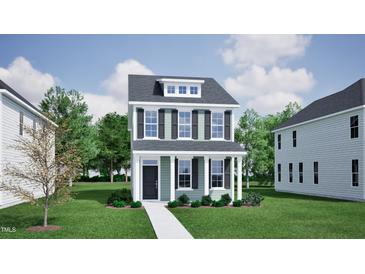 Charming two-story home featuring a welcoming front porch, well-manicured lawn, and classic architectural details at 755 Georgia'S Landing Pkwy # 116, Raleigh, NC 27603