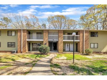 Three story apartment building featuring brick facade and second floor balconies, complimented by a green lawn at 1283 Schaub Dr # B, Raleigh, NC 27606