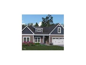 Charming single-story home with a two-car garage, dormer, and well-maintained landscaping at 146 Surles Landing Way, Benson, NC 27504