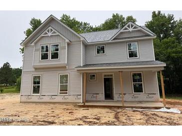 Charming two-story home with light gray siding and inviting front porch details at 1945 Cranes Creek Rd, Cameron, NC 28326