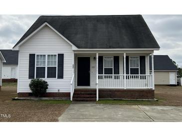 Charming home featuring a cozy front porch, white siding, and black shutters at 247 Anna St, Lillington, NC 27546