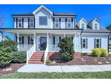 Charming two-story home with a welcoming front porch, beautiful landscaping, and classic curb appeal at 357 Riverwood Dr, Clayton, NC 27527