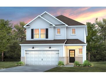 Charming two-story home showcasing a well-manicured lawn and attached two-car garage at 441 Providence Springs Ln, Fuquay Varina, NC 27526
