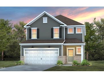 Charming two-story home with gray siding, white trim, and a welcoming two-car garage at 509 Providence Springs Ln, Fuquay Varina, NC 27526