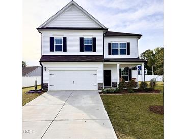 Charming two-story home with a spacious two-car garage and well-maintained lawn at 5117 Farm Barn Ln, Raleigh, NC 27603
