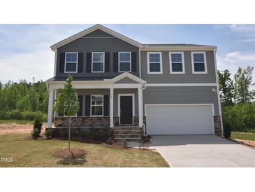 Charming two-story home featuring gray siding, black shutters, and an attached two-car garage at 55 Cordoba Dr, Franklinton, NC 27525
