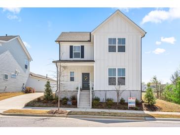 Charming two-story home with a modern farmhouse design and a well-manicured front yard at 5800 Agrinio Way, Raleigh, NC 27603