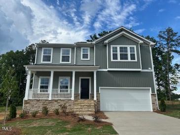 Charming two-story home with a covered porch and a two-car garage at 70 Cordoba Dr, Franklinton, NC 27525