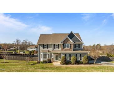 Charming two-story home featuring gray siding, stone accents, and a well-manicured lawn at 1036 Butterfly Cir, Wake Forest, NC 27587