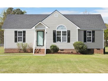 Charming single-story home with light siding, black shutters, and a well-manicured front lawn at 105 Seminole Dr, Wendell, NC 27591