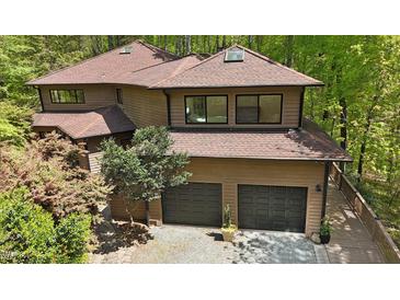 Stunning exterior view of a modern home featuring a two-car garage and pristine landscaping at 111 Standing Rock Rd, Chapel Hill, NC 27516