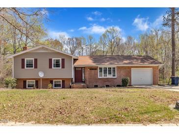 Charming home featuring a blend of brick and siding, with a well-maintained lawn and attached garage at 215 Longview Dr, Smithfield, NC 27577
