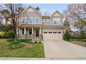 Charming two-story home with a well-manicured lawn and an attached two-car garage at 3108 Bluff Oak Dr, Cary, NC 27519