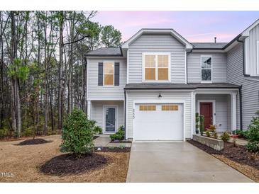 Charming two-story home with gray siding, manicured landscaping, and attached one-car garage at 4220 Congleton Pl, Durham, NC 27703